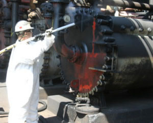 crew member performing dry ice blast cleaning