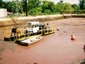 hydraulic dredge on a sludge pond